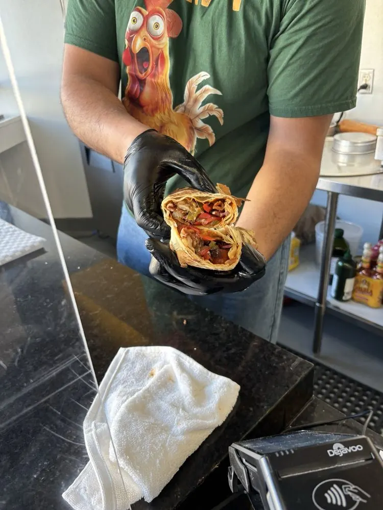 Moe holding a sandwich